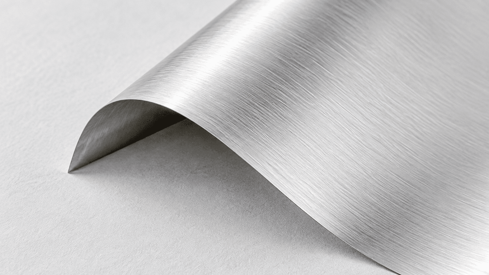A folded sheet of brushed silver with natural directional texture